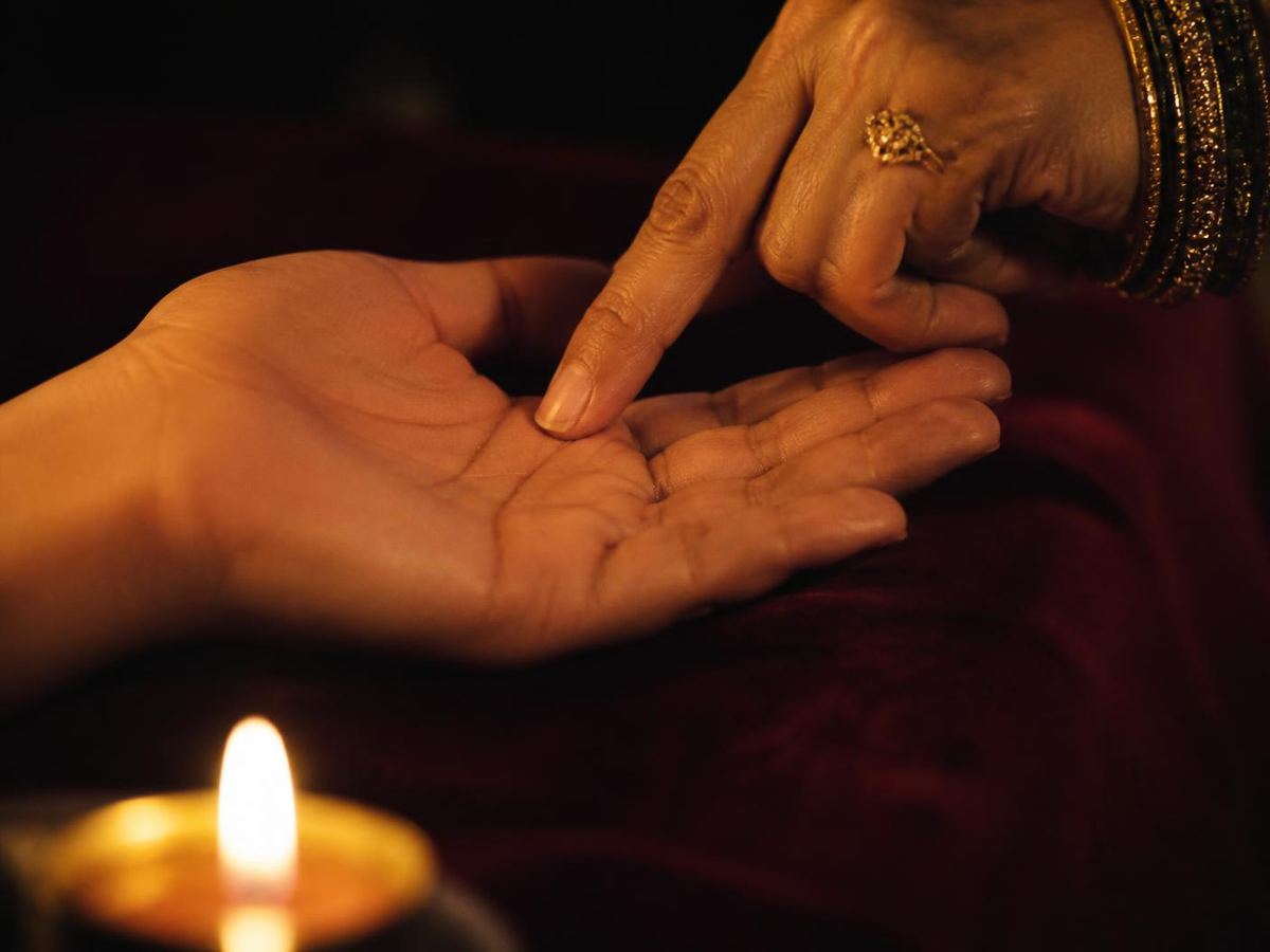 An open palm read by candlelight